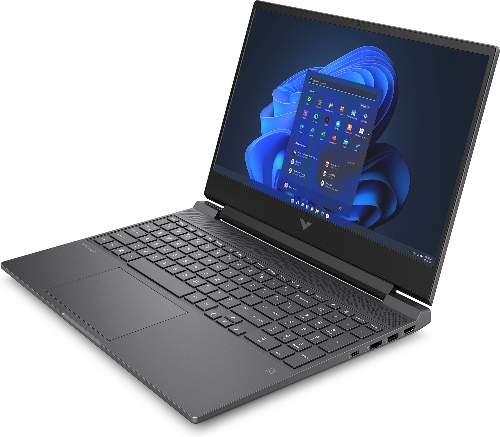 Laptop auf einem Tisch geöffnet, zeigt Windows 11 Desktop mit verschiedenen App-Symbolen.