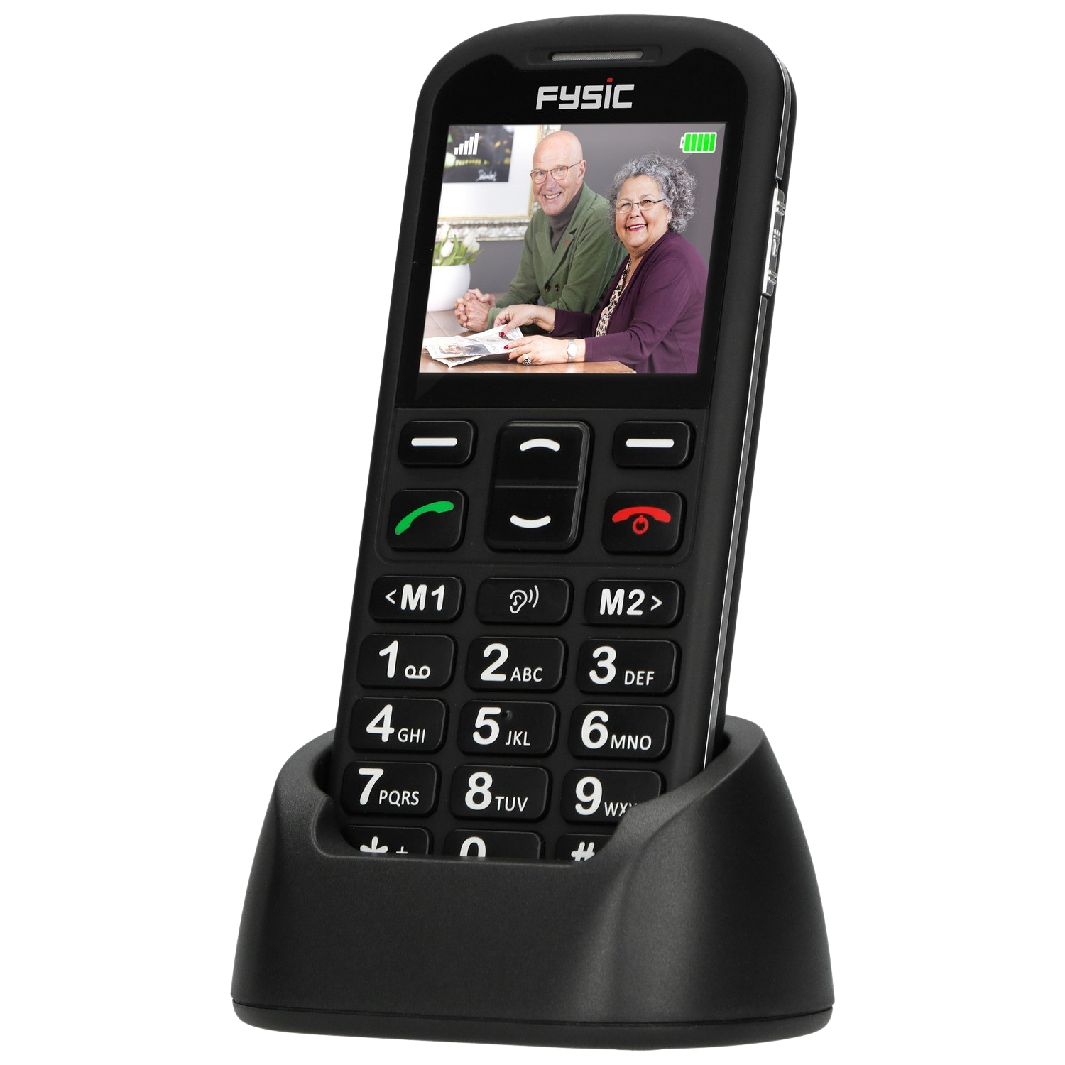 Black Fysic mobile phone in charging cradle with elderly couple on screen.