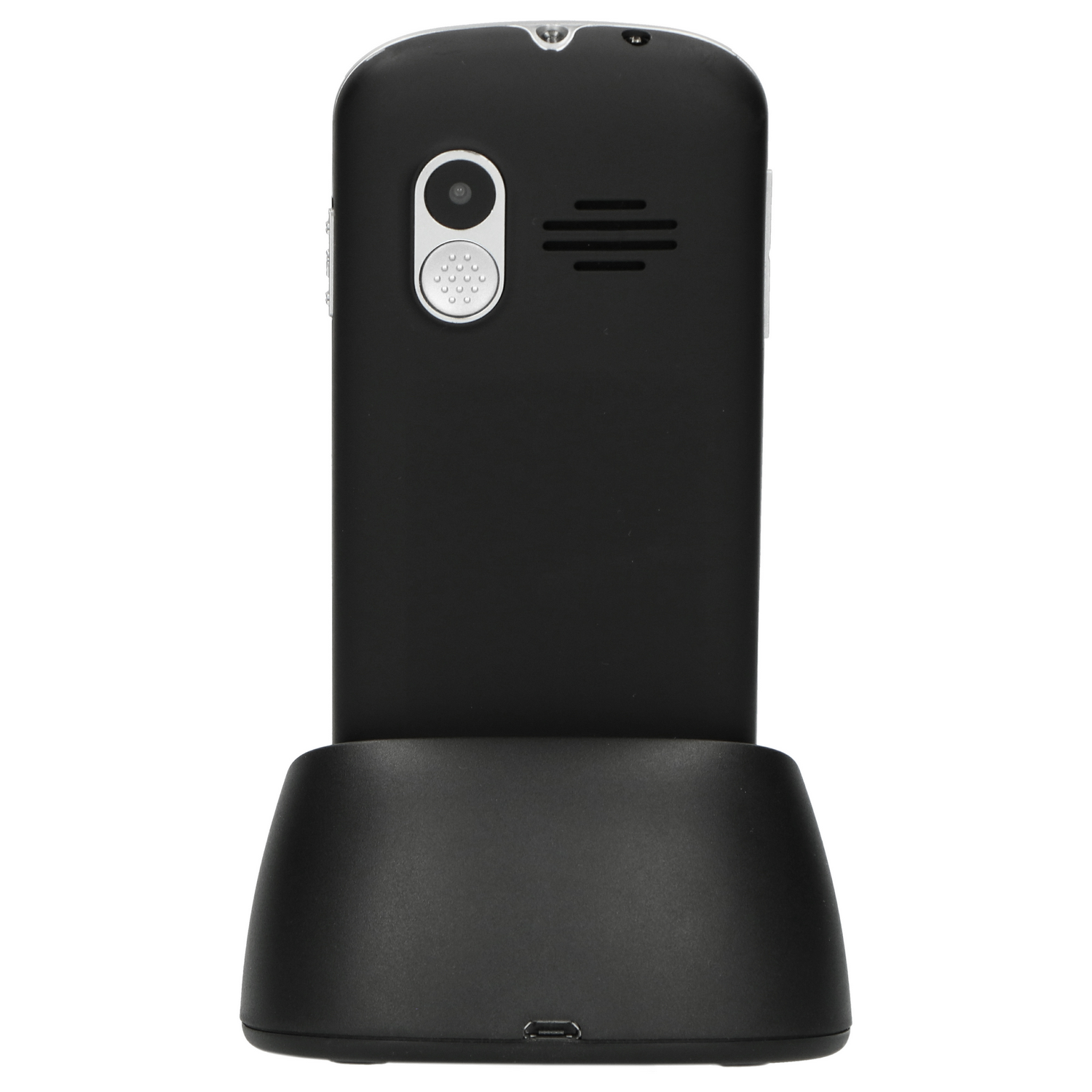 Black phone with a camera on a charging base. The phone is on a base.
