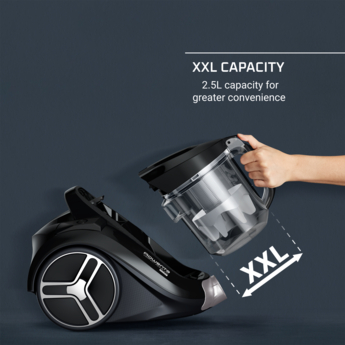 Aspirateur noir avec un conteneur à poussière amovible, le texte XXL CAPACITY est visible.