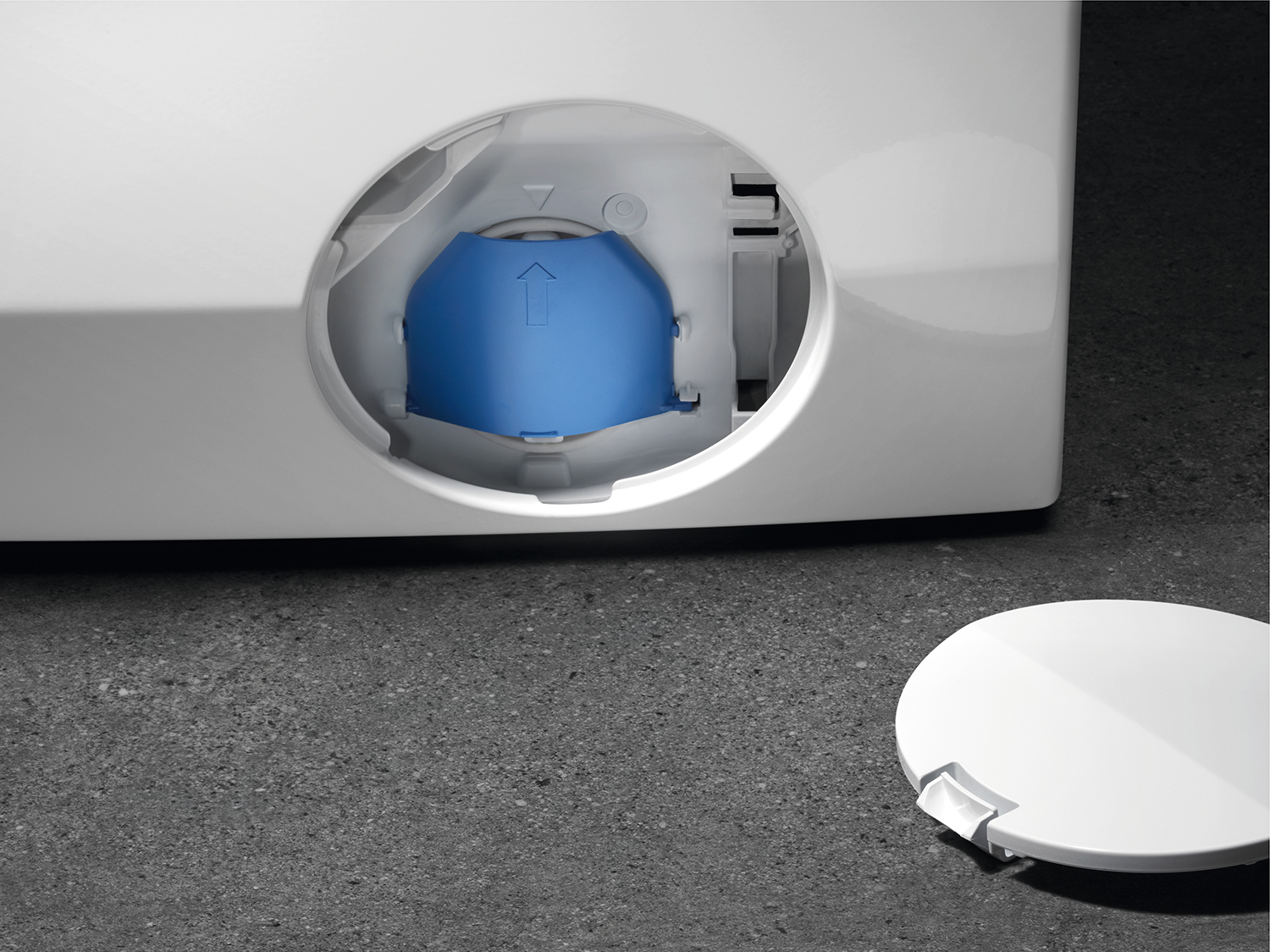 A blue cap on the inside of a washing machine.