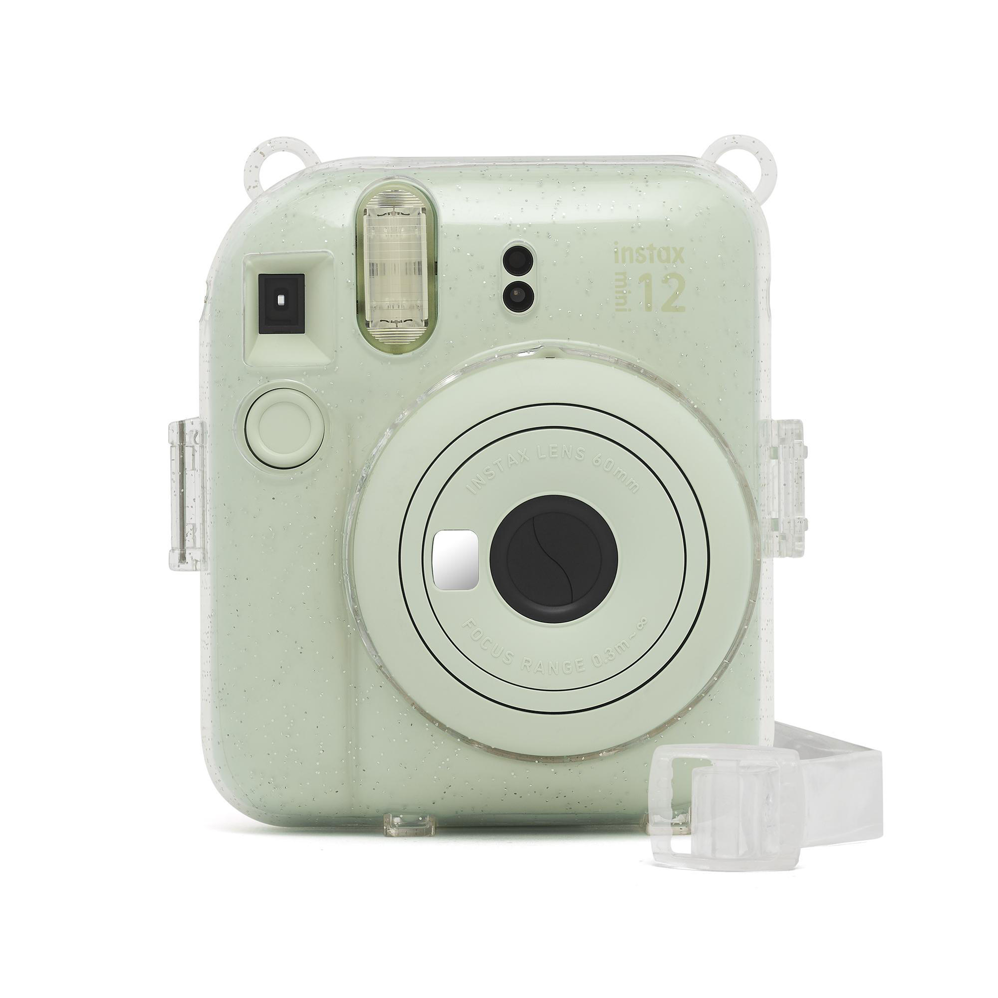Eine mintgrüne Instax Mini 12 Kamera mit transparentem Riemen, Objektiv und Blitz auf weißem Hintergrund.