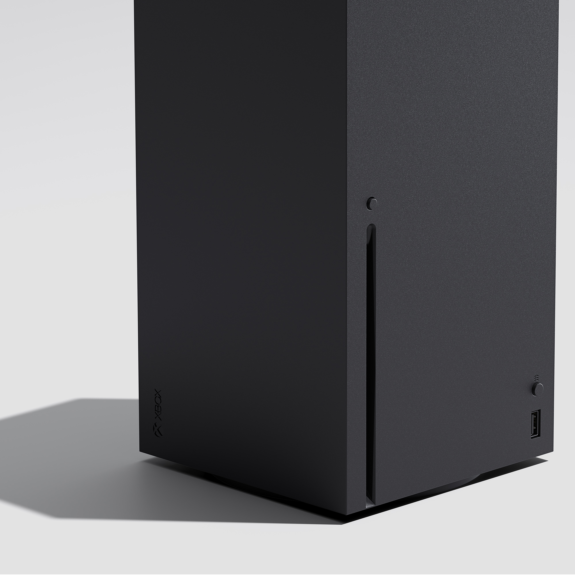Schwarze Xbox Series X Konsole. Vertikale Ausrichtung. Seitenansicht mit Lüftungsschlitzen und Logo.
