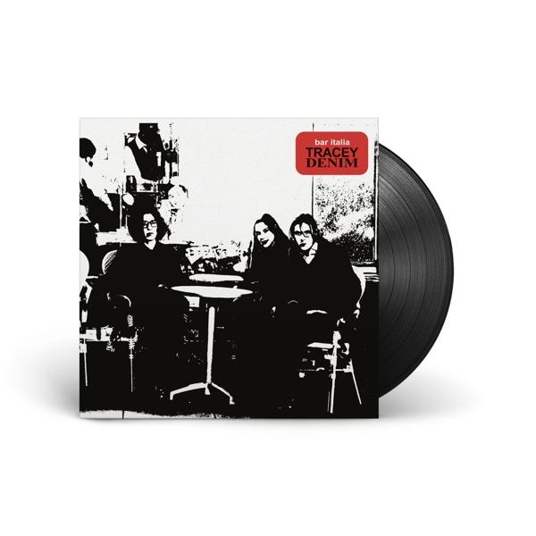 Albumcover: Drei Personen sitzen an einem Tisch. Das Album ist eine schwarze Vinyl-Schallplatte.