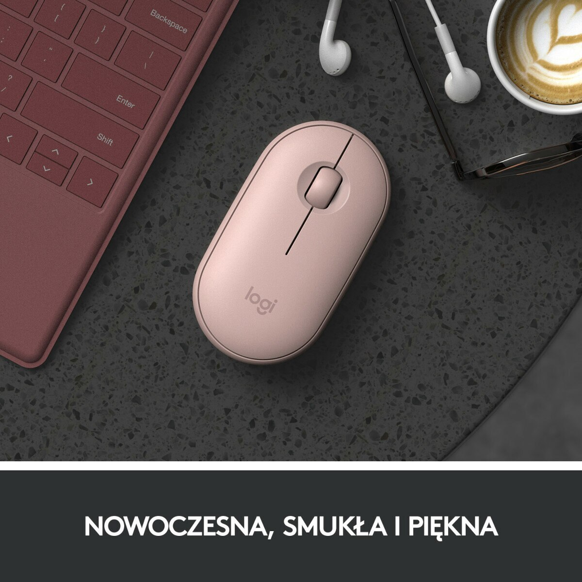 Różowa mysz komputerowa na ciemnej powierzchni ze słuchawkami, klawiaturą i filiżanką.