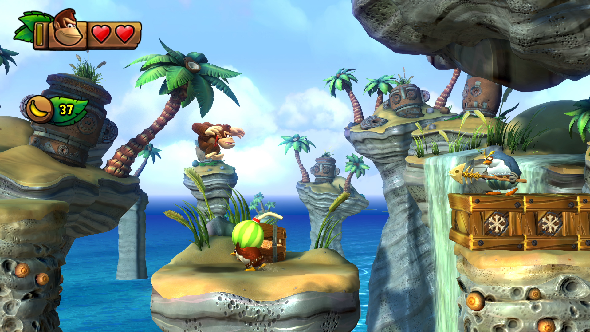 Donkey Kong game scene with Donkey Kong, enemies, and a treasure chest on a tropical island.