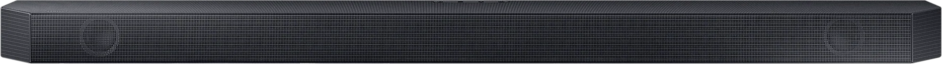 Fekete soundbar. A soundbar téglalap alakú, rácsszerű textúrával, sötét felületre helyezve.
