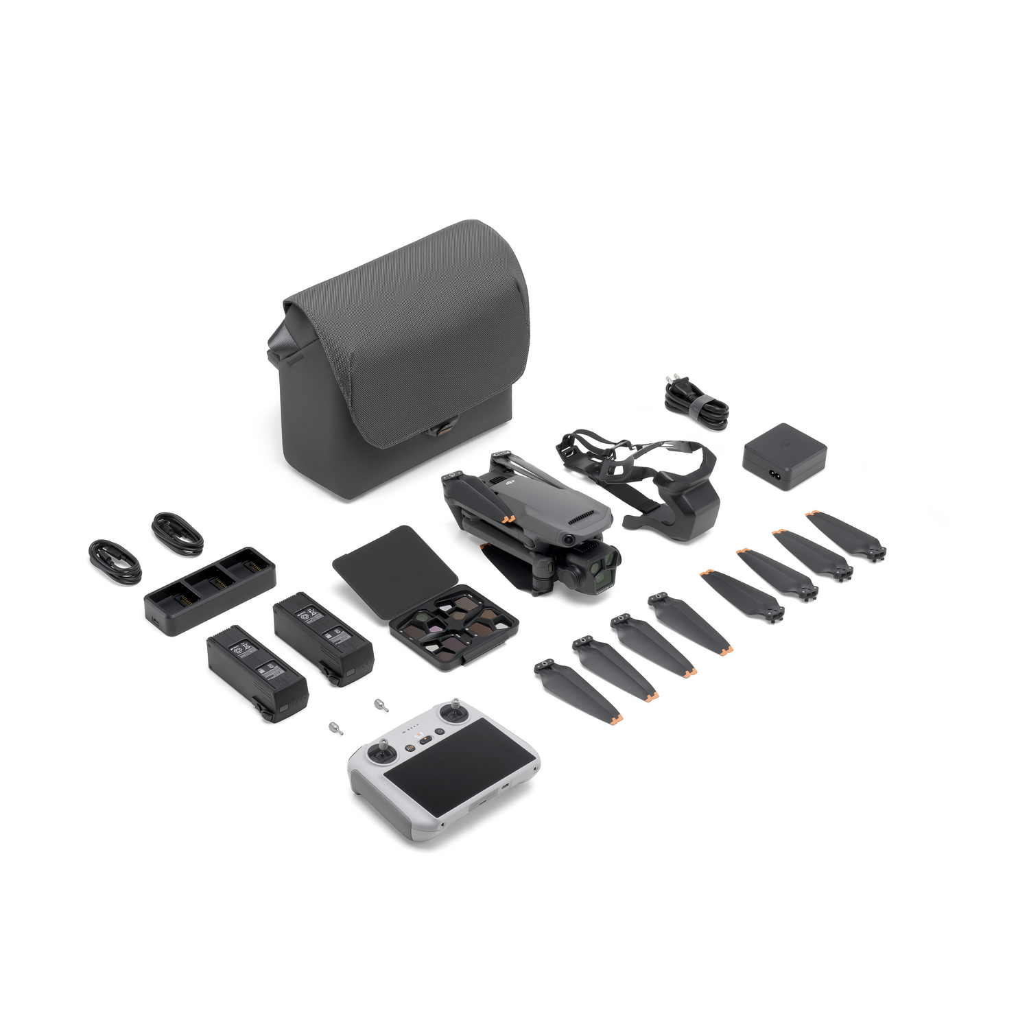 Drone en accessoires netjes gerangschikt: tas, controller, batterijen, props en oplader.