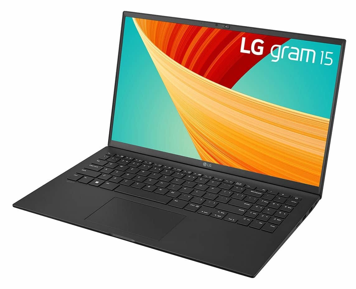 Czarny laptop z otwartym ekranem. Ekran wyświetla kolorowy obraz. Laptop stoi na białej powierzchni.