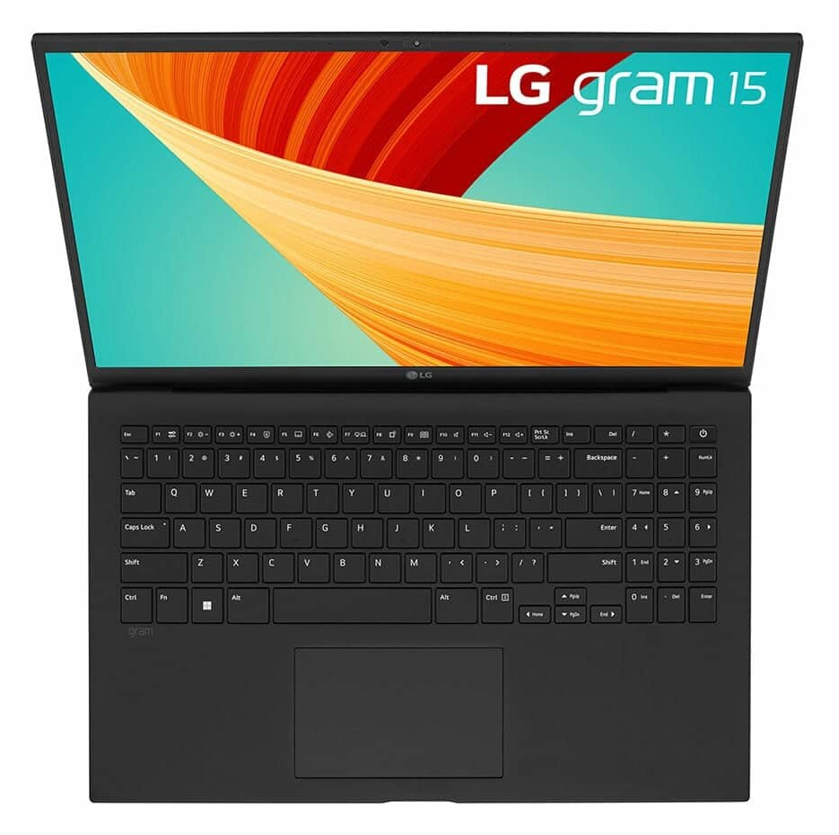 Czarny laptop z otwartą pokrywą, pokazujący klawiaturę i ekran z kolorowym designem.