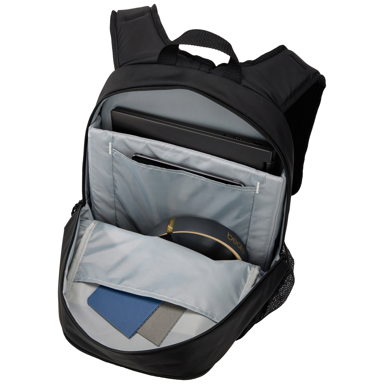 Black backpack open, showing a laptop, headphones, and other items.