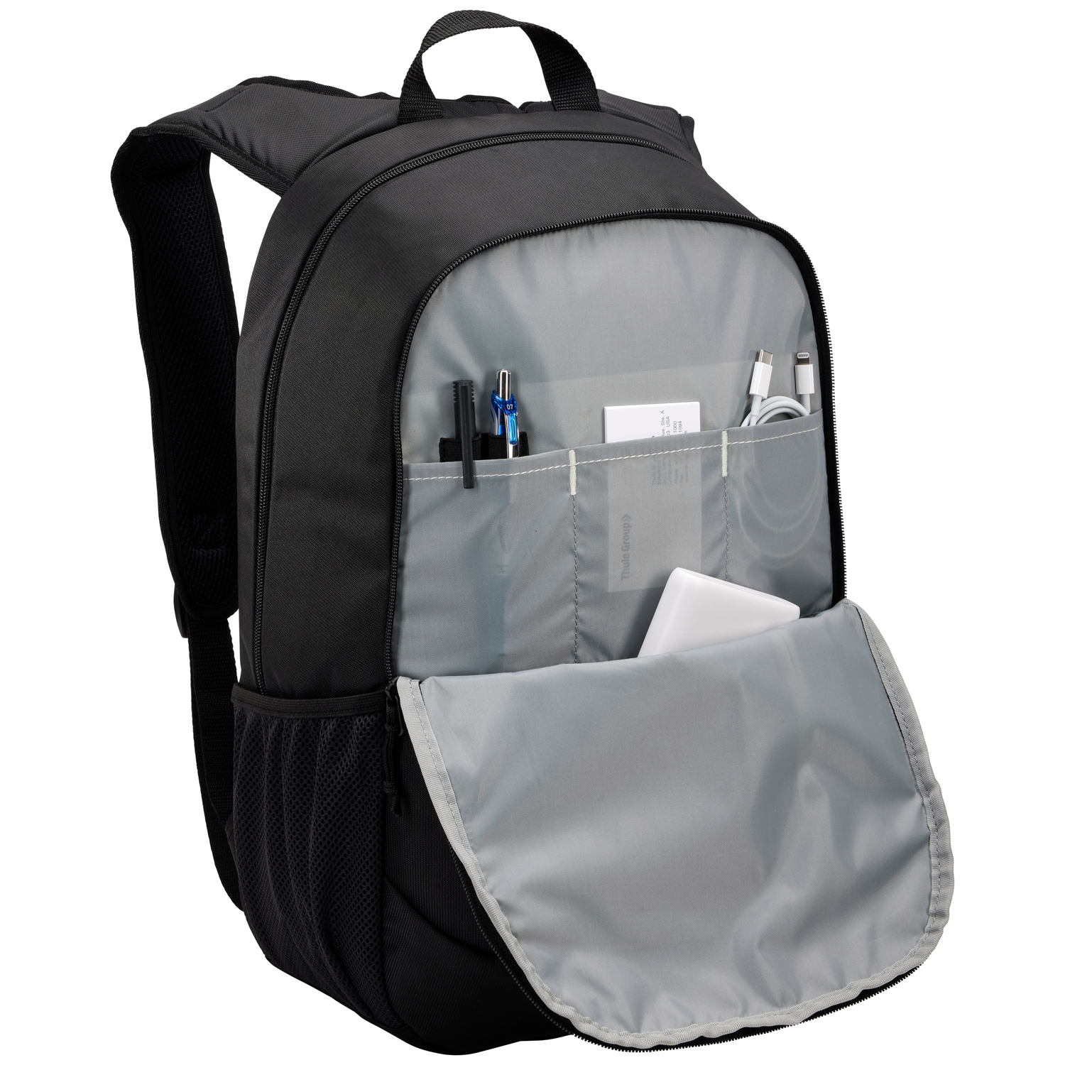 Black backpack open with pens, cables, and a power bank inside. The backpack has gray lining.