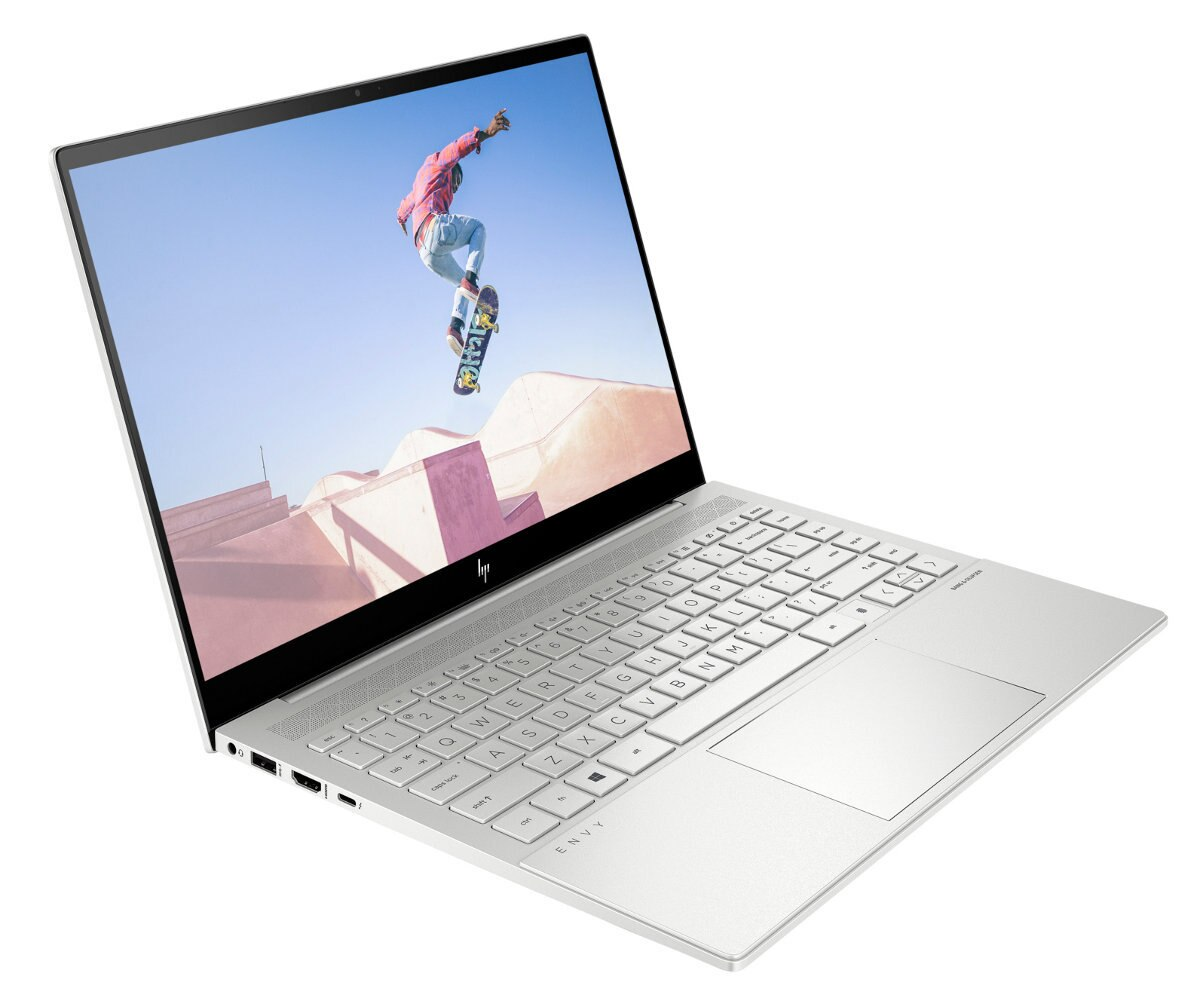 Biały laptop, otwarty, pokazujący klawiaturę i ekran.