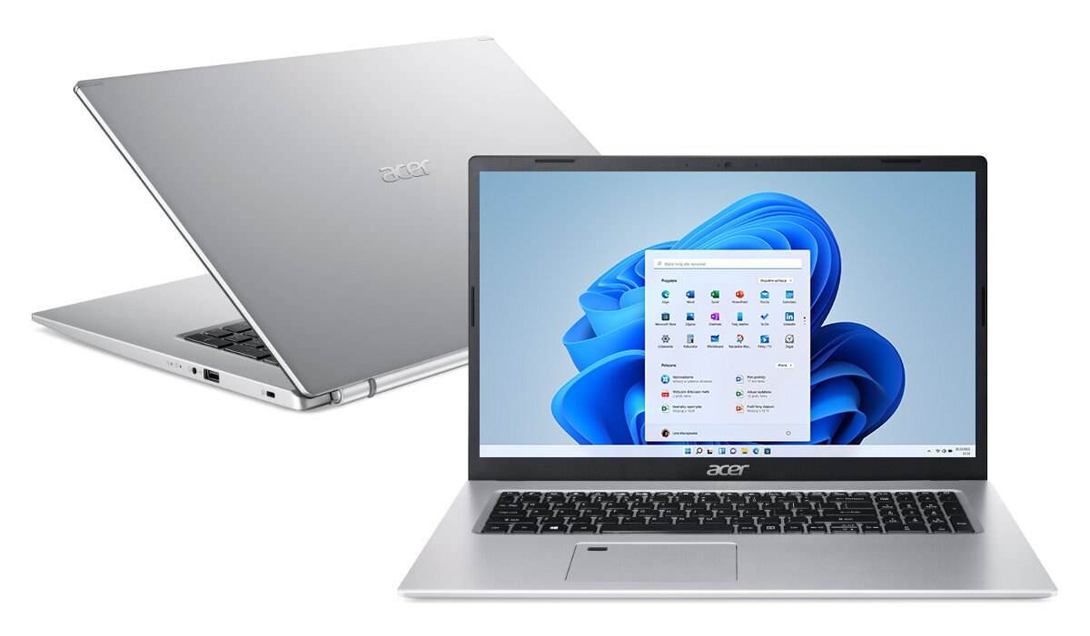 Srebrny laptop otwarty, pokazujący ekran Windows, drugi laptop widoczny w tle.