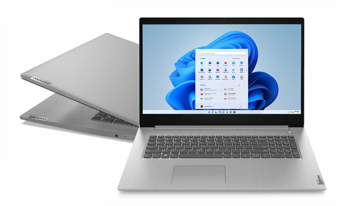 Srebrny laptop otwarty, pokazujący Windows 11. Drugi laptop po lewej.