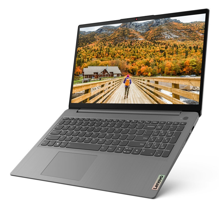 Laptop wyświetlający krajobraz z osobą idącą po drewnianym moście.