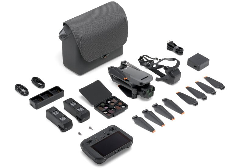 Zestaw drona z wieloma akcesoriami, w tym etui, pilotem, bateriami i śmigłami. Białe tło.