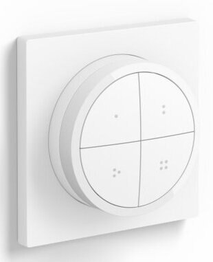 Biały kwadrat z okrągłą tarczą, z czterema sekcjami, na białej ścianie.