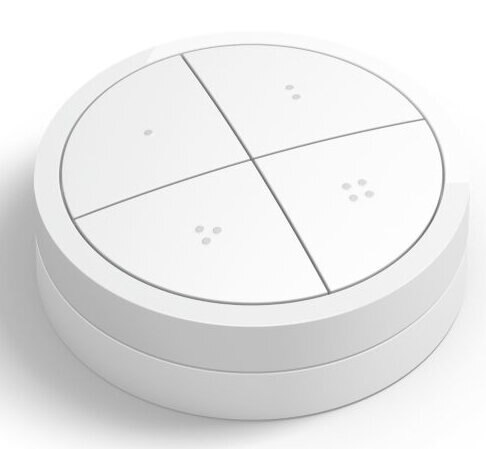 Biały, okrągły przycisk smart home z 4 sekcjami. Małe kropki wskazują funkcje. Białe tło.