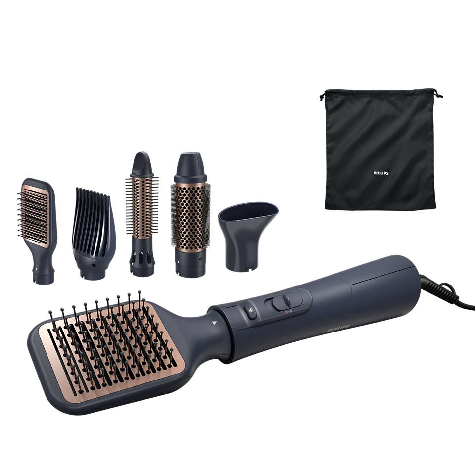 A Philips hair styling tool with multiple attachments and a storage bag, all on a white surface.