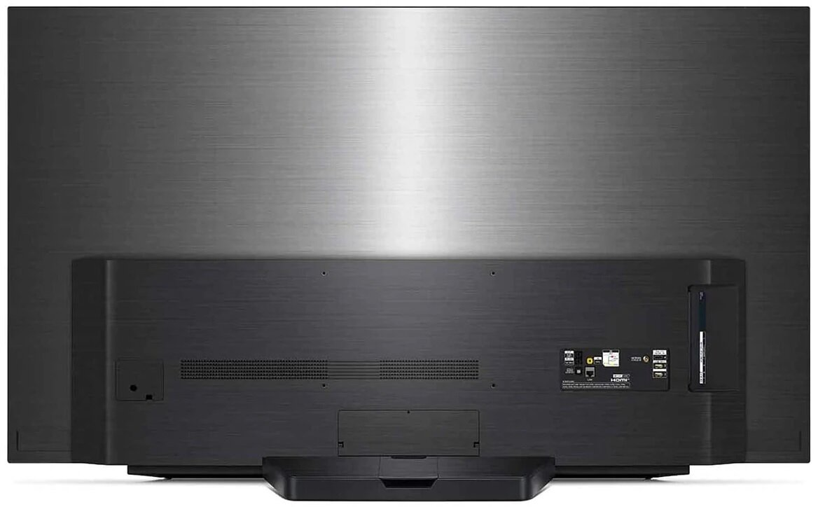 Tył czarnego telewizora z portami i stojakiem na ciemnoszarym tle.