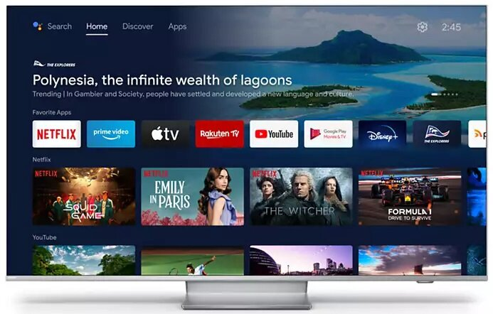 Ekran telewizora wyświetlający interfejs Android TV z ikonami aplikacji i tłem z naturalną scenerią.