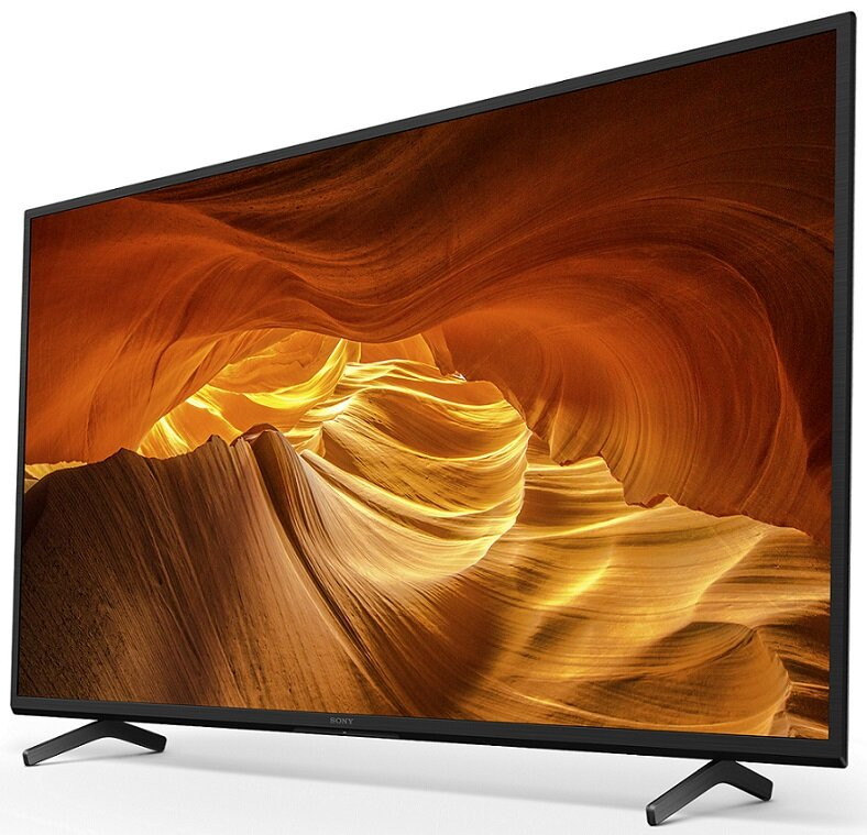 Telewizor Sony wyświetlający scenę kanionu. Telewizor jest czarny, z czarnym stojakiem. Tło to złoty kanion.