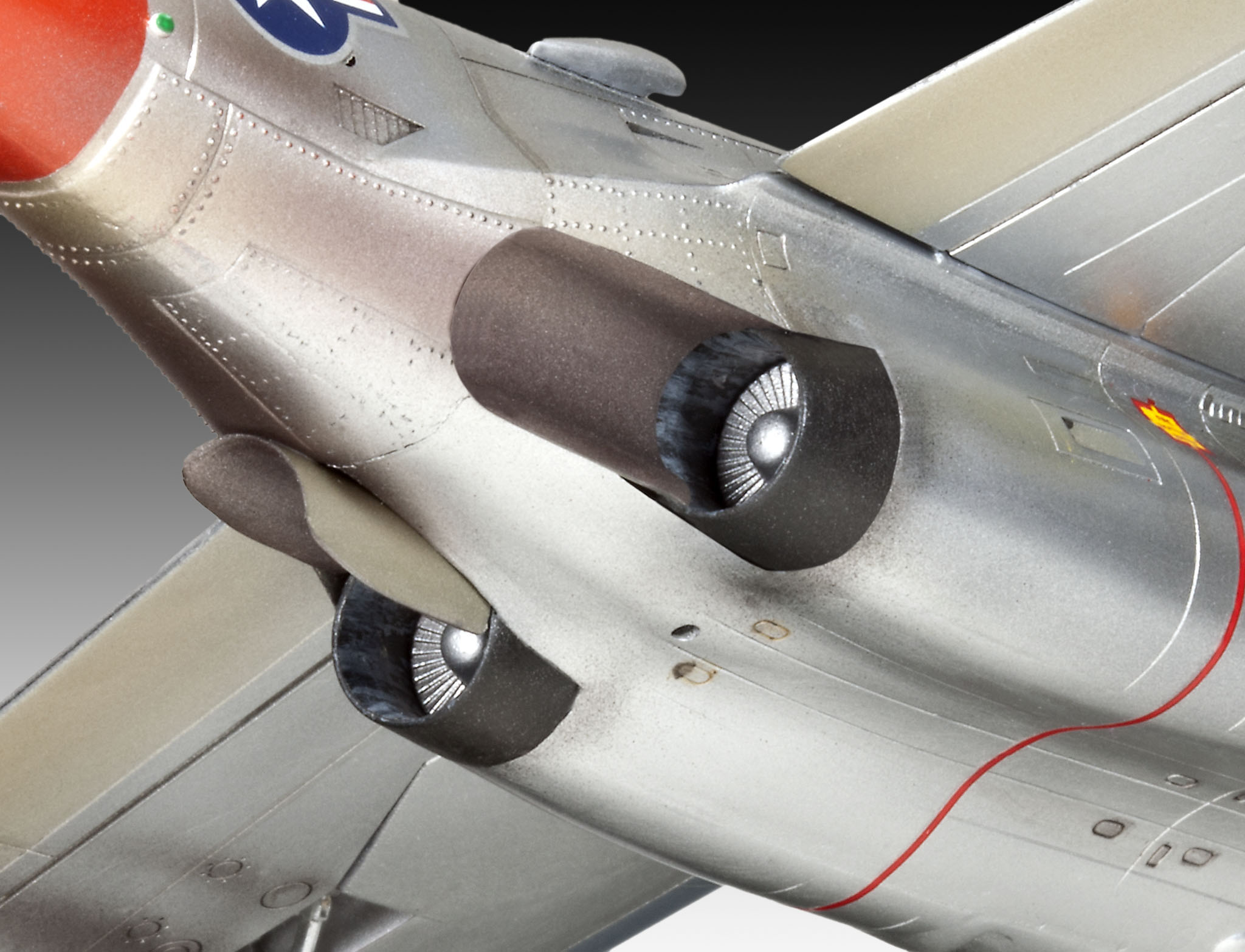 Nahaufnahme des Motors eines Modellflugzeugs, die Auspufföffnungen zeigend.