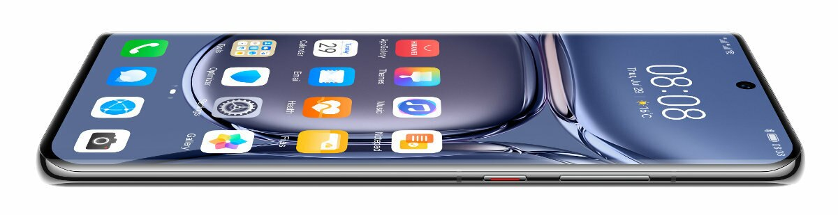 Telefon komórkowy, pokazujący interfejs i ekran, leżący na białej powierzchni.