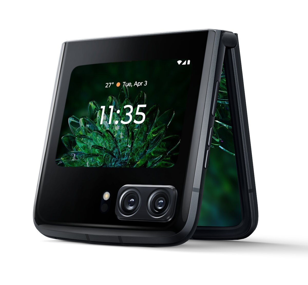 Czarny składany telefon, otwarty. Wyświetla godzinę i datę. Zielone tło. Widoczny podwójny aparat.