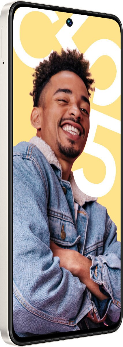 Uśmiechnięty mężczyzna w dżinsowej kurtce. Biały telefon widoczny po lewej stronie obrazu.