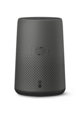 Un haut-parleur intelligent gris avec une partie inférieure perforée et quelques boutons/ports à l'arrière.