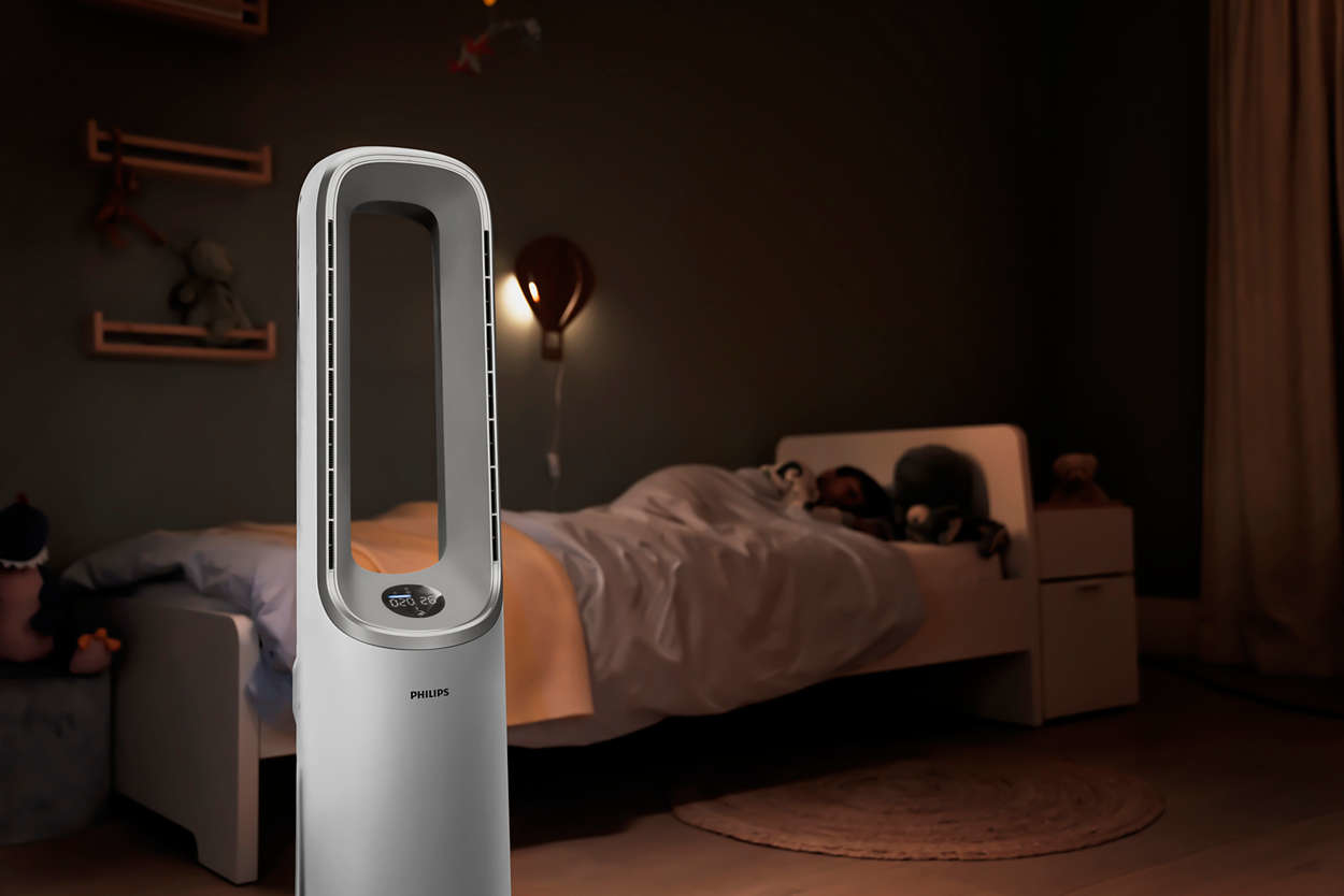 White and gray fan in a bedroom. A bed and toys are visible.