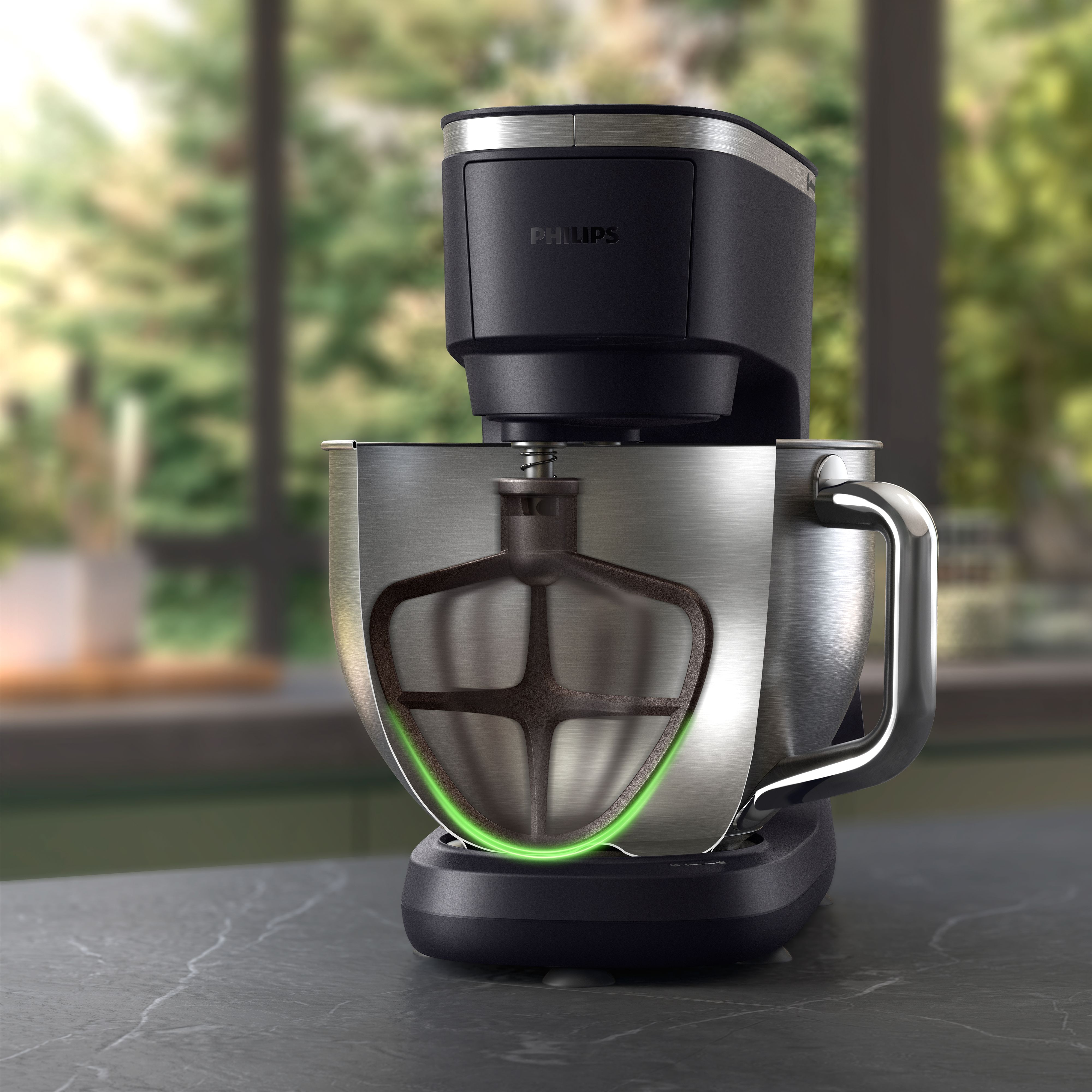 Black Philips stand mixer. Bowl with a beater. Green glow.