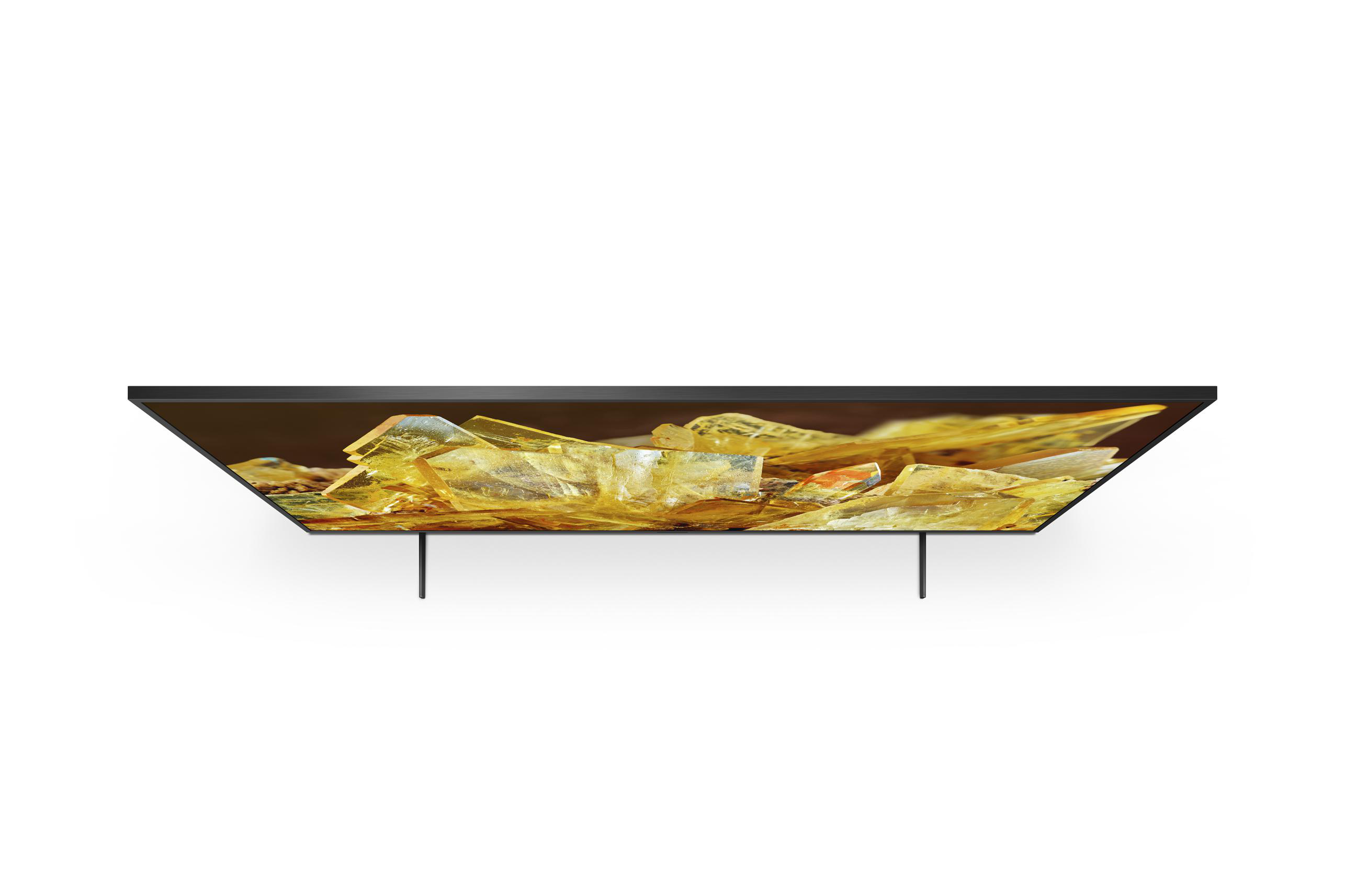 Ein Fernseher von oben, mit goldenem Bildschirm und schwarzen Beinen.