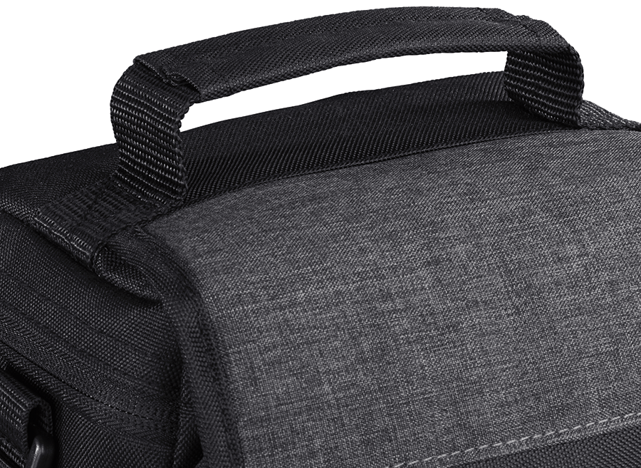 Close-up of a black bag handle, made of a fabric material with a gray texture.