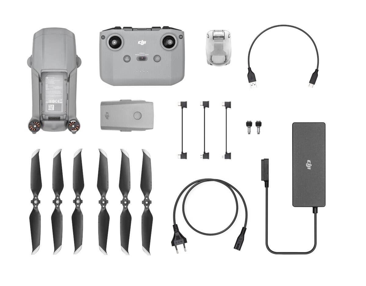 Zestaw drona DJI z akcesoriami: kontroler, bateria, śmigła, ładowarka i kable.
