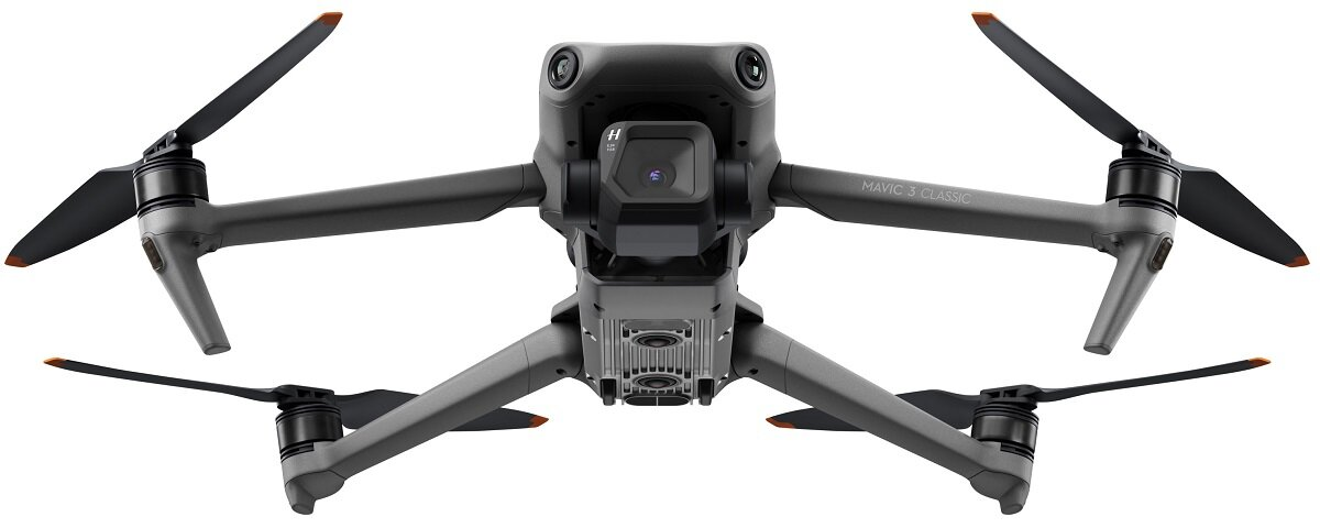 Szary dron z góry, z rozłożonymi śmigłami.