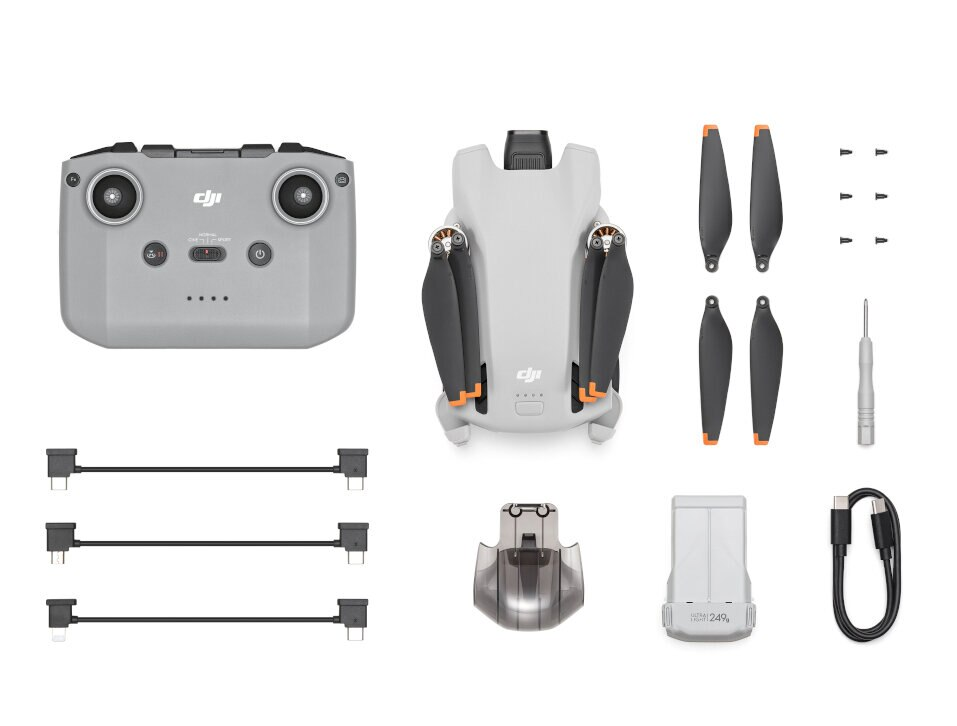 Dron i akcesoria ułożone na białej powierzchni.