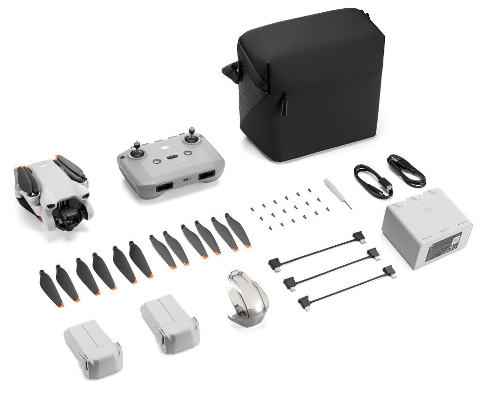 Zdemontowany dron z akcesoriami, w tym pilotem, bateriami, śmigłami i torbą transportową.