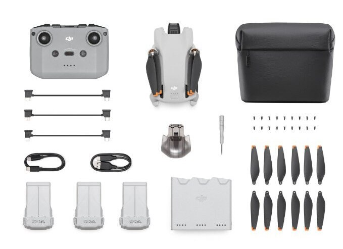 Dron i akcesoria: pilot, baterie, śmigła oraz pokrowiec transportowy.