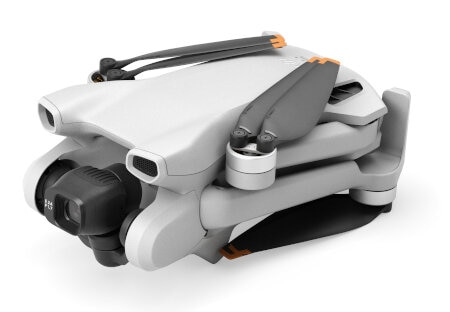 Biało-szary dron ze złożonymi śmigłami, ustawiony pod kątem w prawo. Tło jest białe.