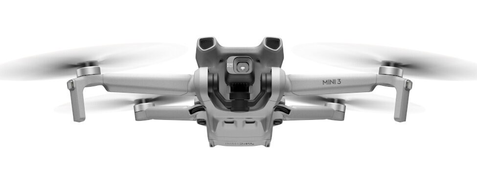 Mały szary dron z przednią kamerą i śmigłami. Białe tło.