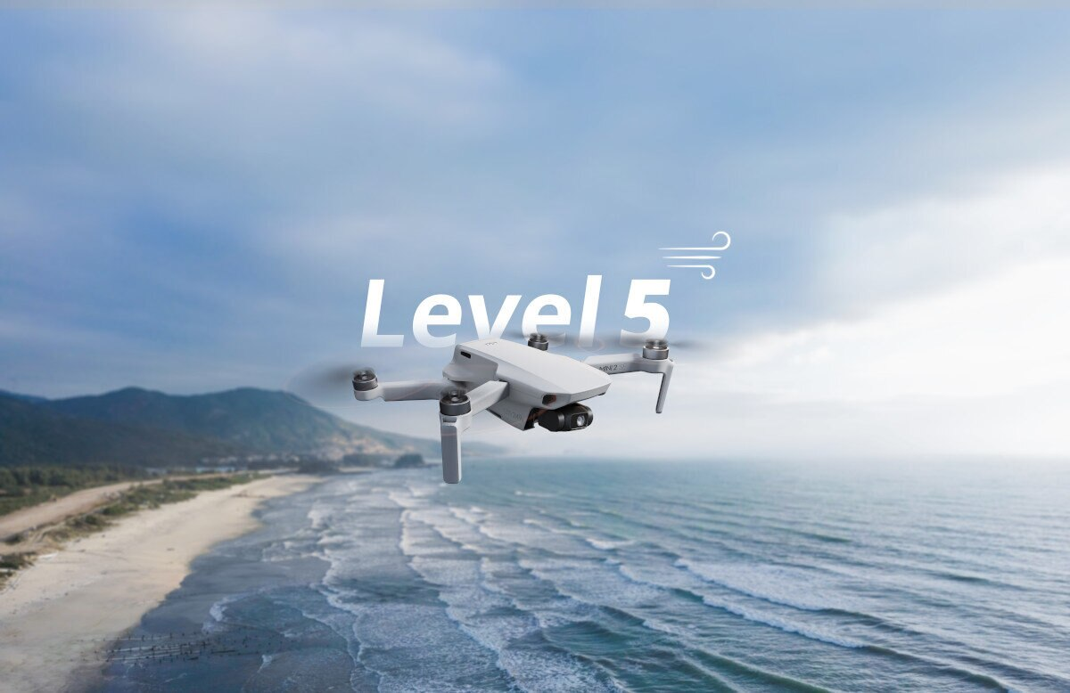 Biały dron w locie nad plażą. Słowa "Level 5" pojawiają się na obrazie.