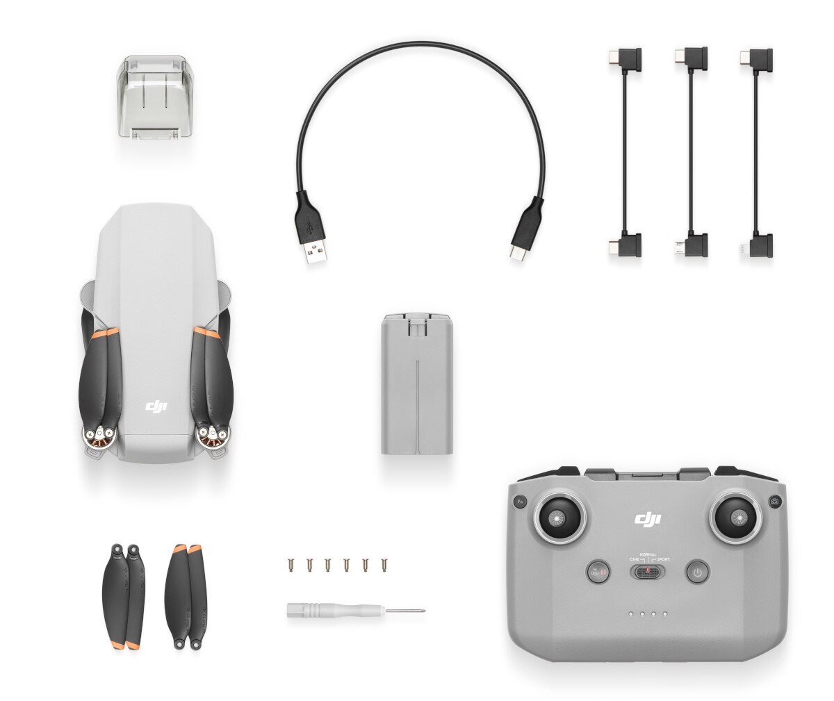 Dron, pilot, bateria, kable do ładowania i części zamienne są ułożone.