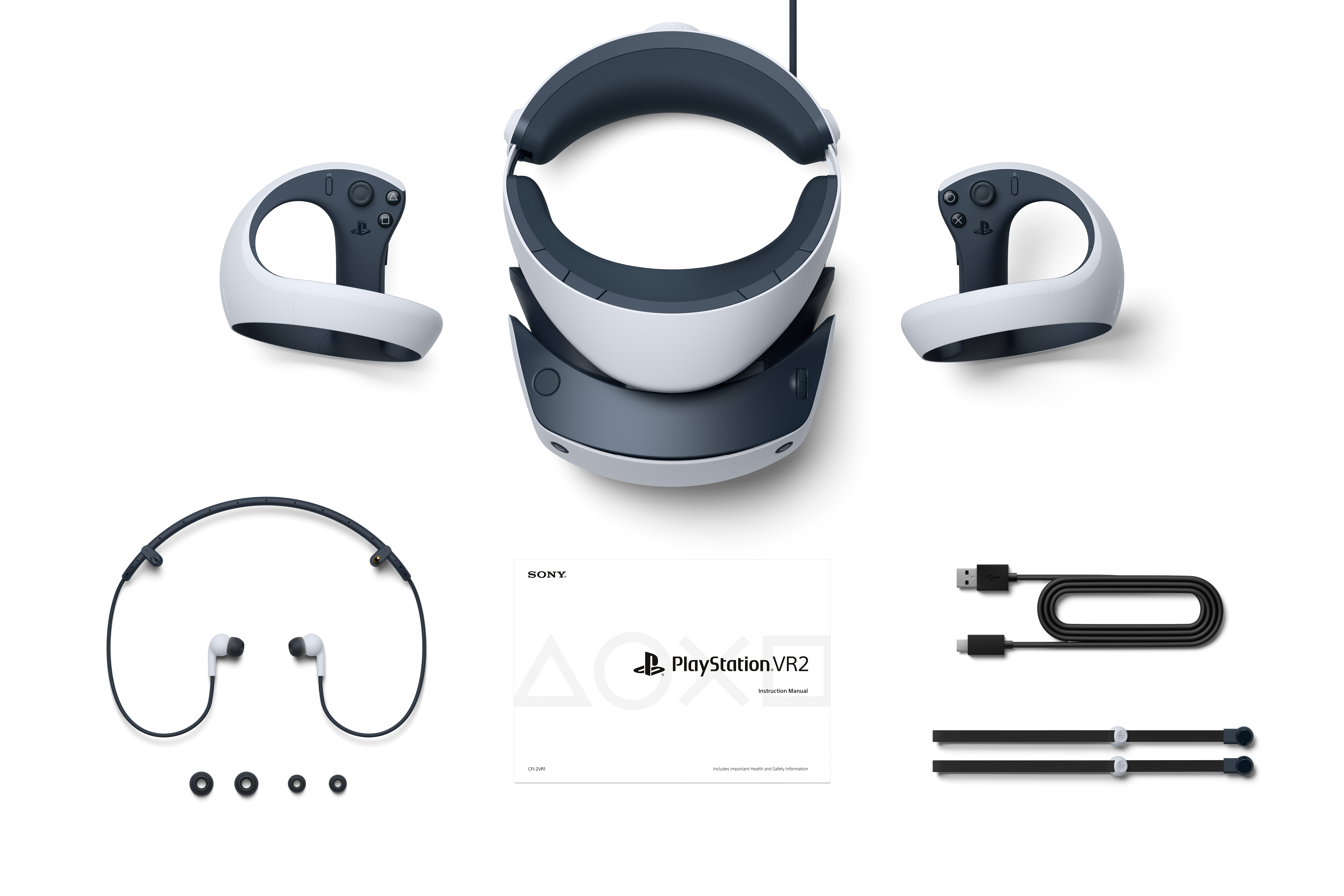 PlayStation VR2-Headset, Controller, Kopfhörer, Kabel und Dokumentation auf weißer Oberfläche.