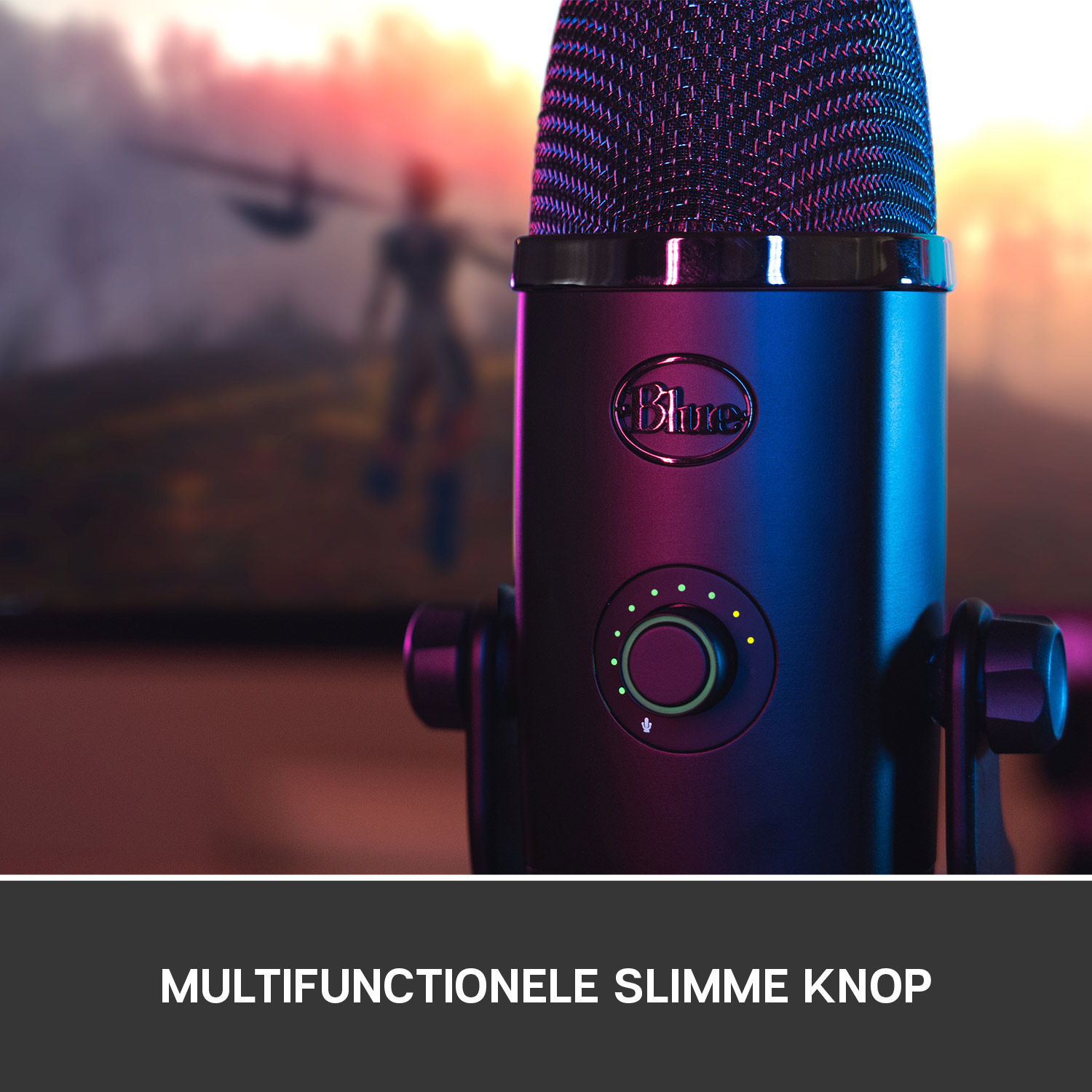 A black microphone with a green button and volume controls. A blurred background is visible.