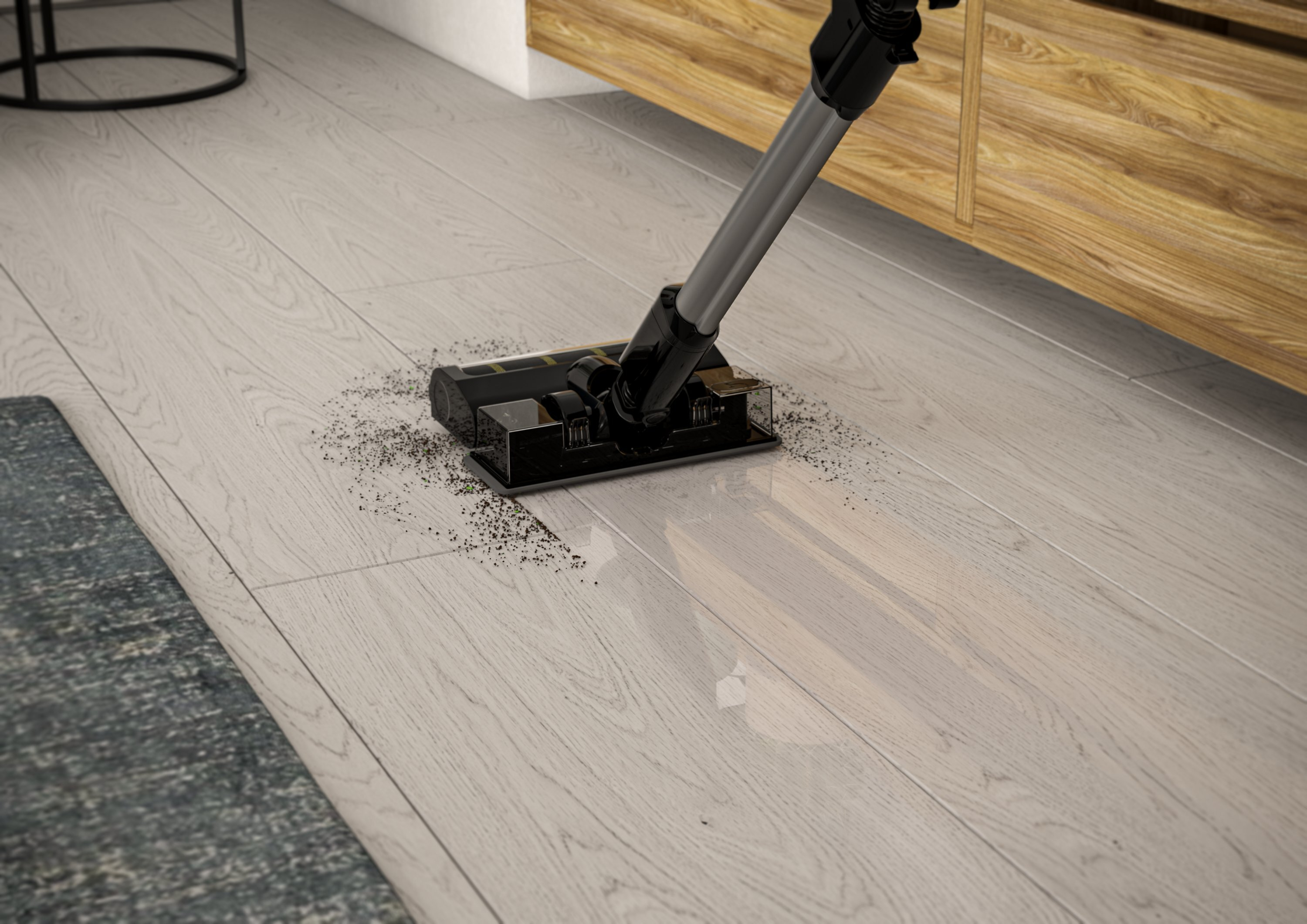 Odkurzacz czyszczący jasną drewnianą podłogę. Ciemne zanieczyszczenia są zasysane. Szary i niebieski dywan w rogu.