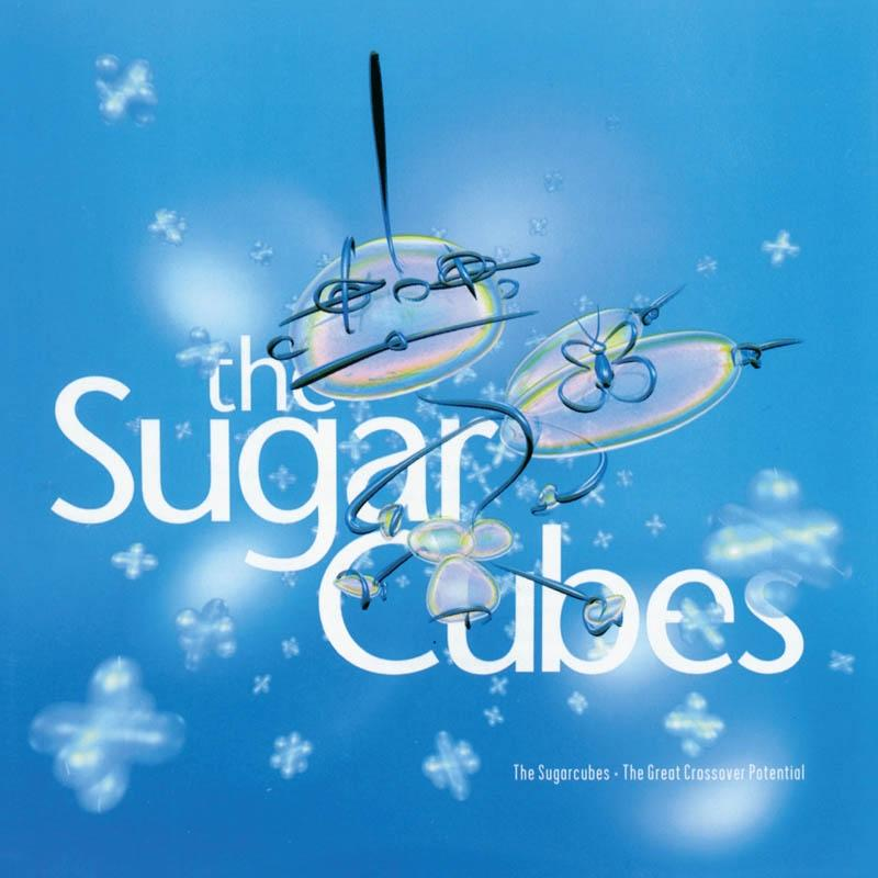 Album borító a "The Sugar Cubes" felirattal, absztrakt formákkal és szöveggel kék háttéren.