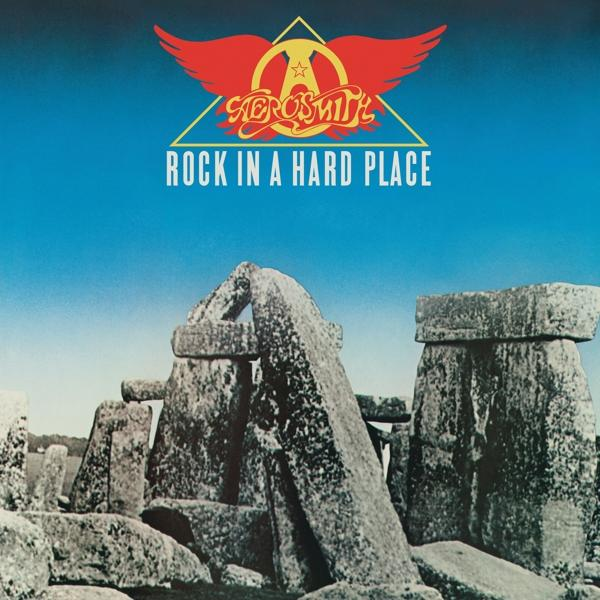 Aerosmith album borítója 'Rock in a Hard Place'. Kő szerkezet és a zenekar logója a kék égbolton.